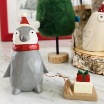 christmas penguin with sleigh with present on top